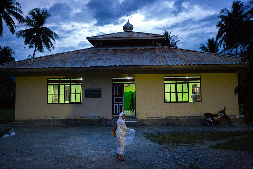 Poso. Mrs Sudarni goes for an evening prays to a mosque.