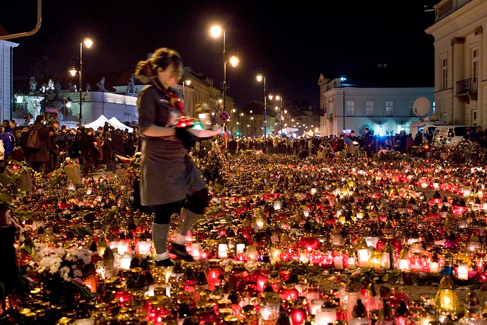 Thousands of candles left by Warsaw residents in front of the Presidential Palace at the evening. Scouts take care of them.