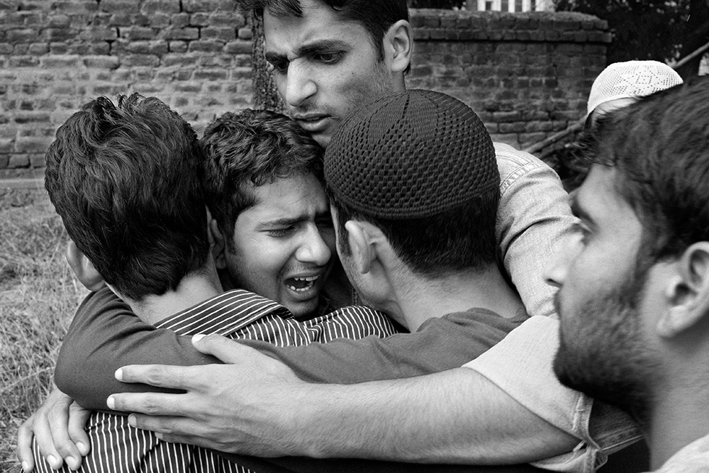 Boys mourn their brother who has been murdered. The body with heavy marks of torments was found on the street. He was a computer science student and, according to locals, had no connections with Kasmiri separatists.